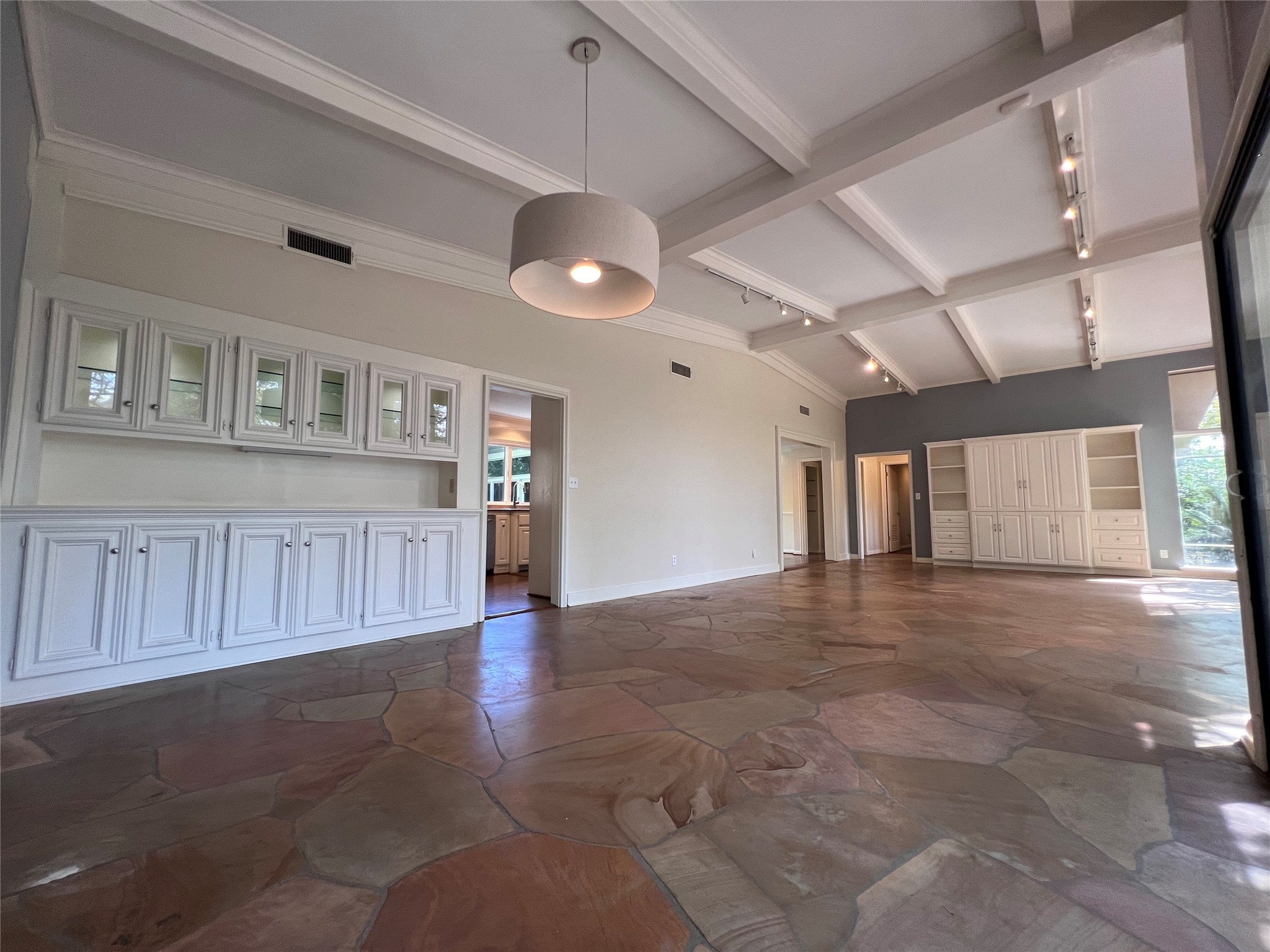 12502 Taylorcrest Road Houston, TX 77024 - Photo 4 of 28 The dining room and den features polished flagstone floors, custom paneled ceiling, built-in buffet with glass front cabinets, mirrored shelves and lighting, and a direct access to the gourmet kitchen.
