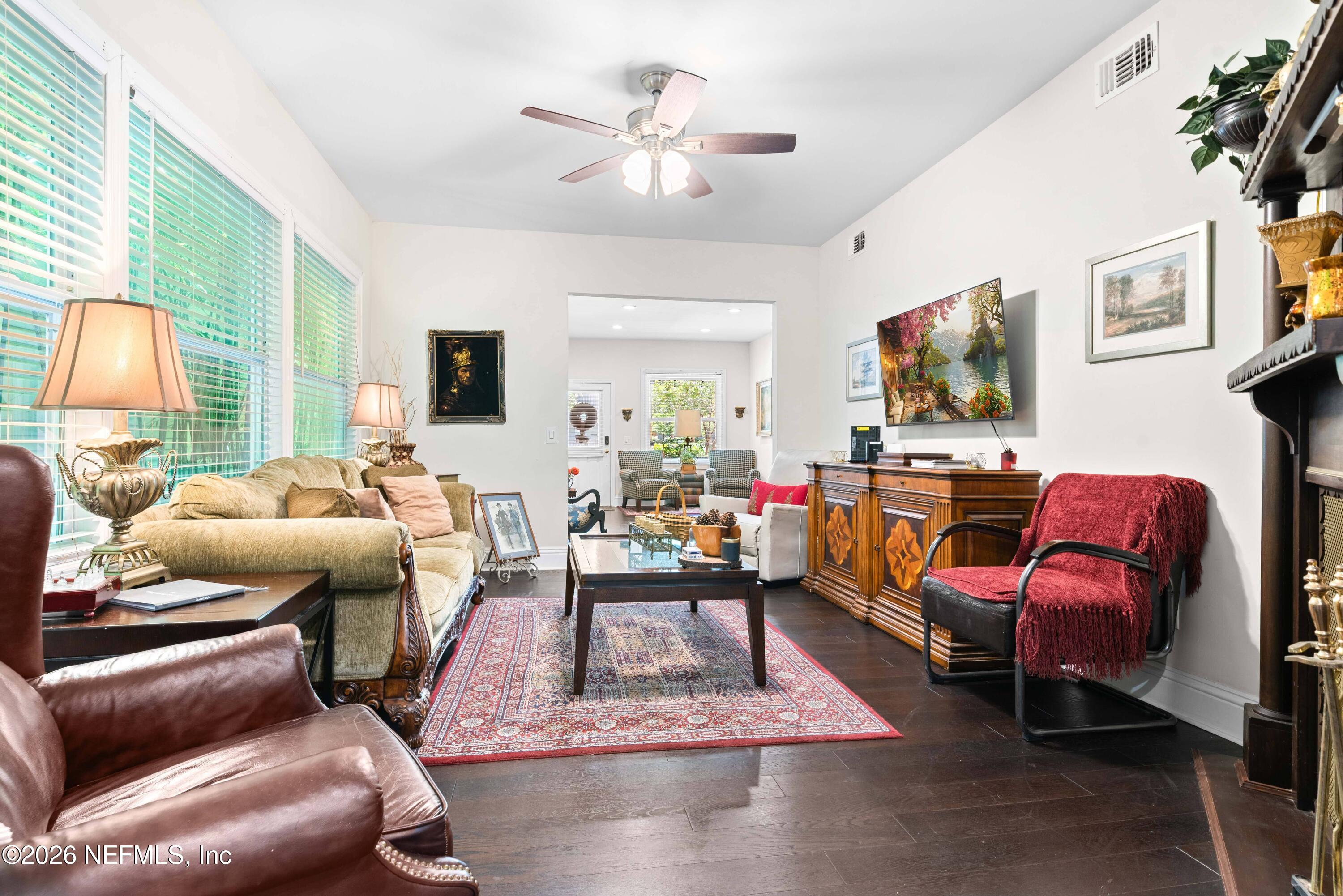 1138 Walnut Street Jacksonville, FL 32206 - Photo 5 of 37 a living room with furniture a flat screen tv and a fireplace