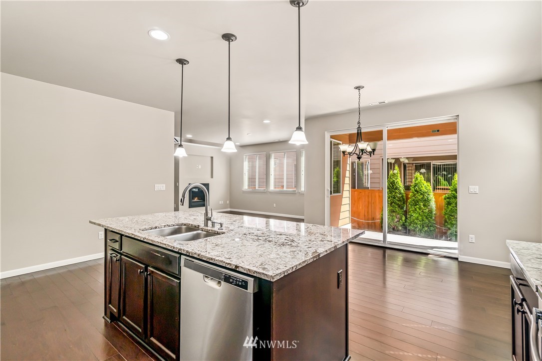 3608 177th Street Southeast Bothell, WA 98012 - Photo 14 of 32 a kitchen with a sink a stove and a wooden floor
