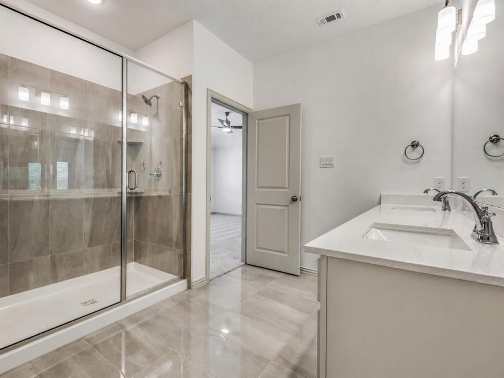 8913 Swallowtail Street Frisco, TX 75035 - Photo 28 of 38 a bathroom with a shower sink and mirror