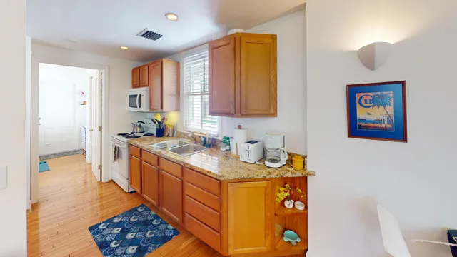 a kitchen with stainless steel appliances granite countertop a sink stove and cabinets