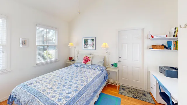 a bedroom with a bed and a dresser in it