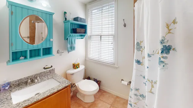 a bathroom with a sink a toilet and a mirror