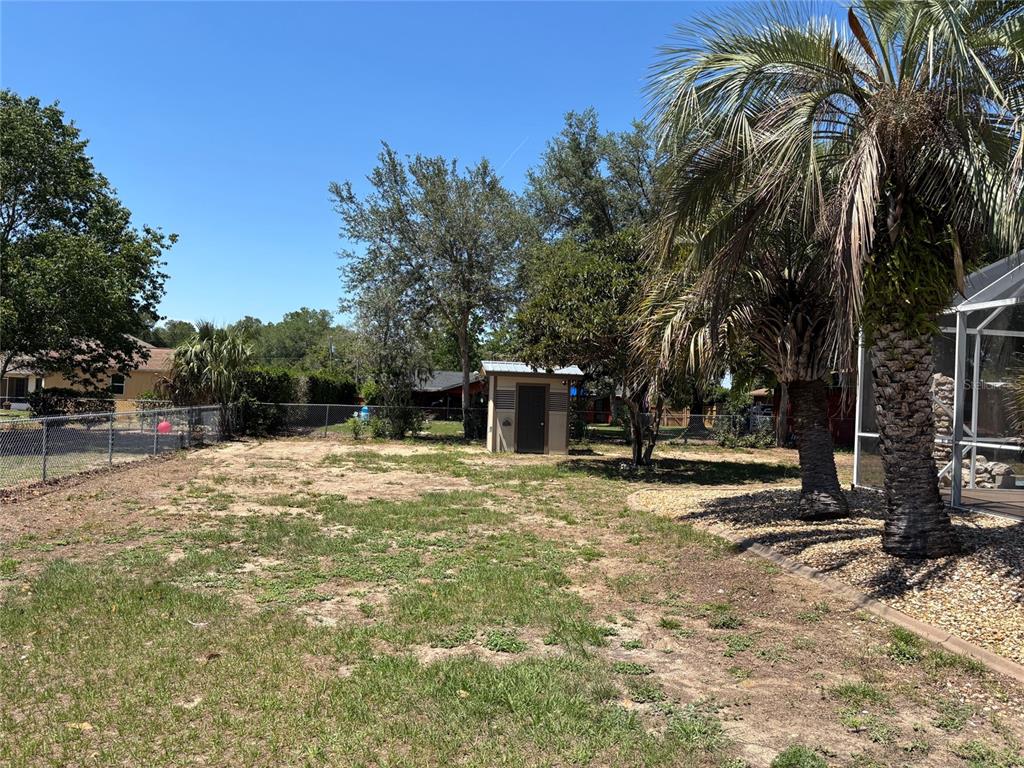 9801 Southeast Sunset Harbor Road Summerfield, FL 34491 - Photo 36 of 37 a view of a backyard with large trees