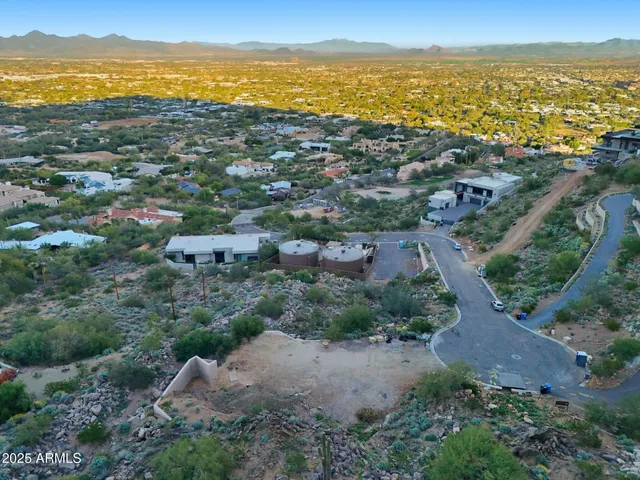 an aerial view of mountains residential house and green space