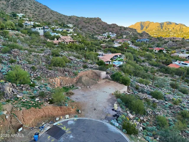 a view of a dry yard with wooden fence