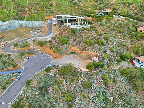 an aerial view of a house with a yard and lake view