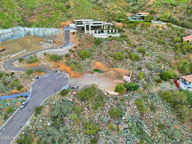 an aerial view of a house with a yard and lake view