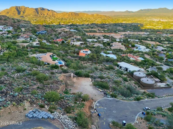 an aerial view of residential houses with outdoor space and ocean view