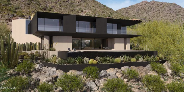 a front view of a house with a yard with wooden fence