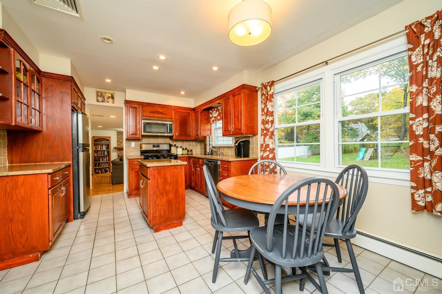 24 Clover Lane Randolph, NJ 07869 - Photo 11 of 59 a dining hall with stainless steel appliances a dining table and chairs