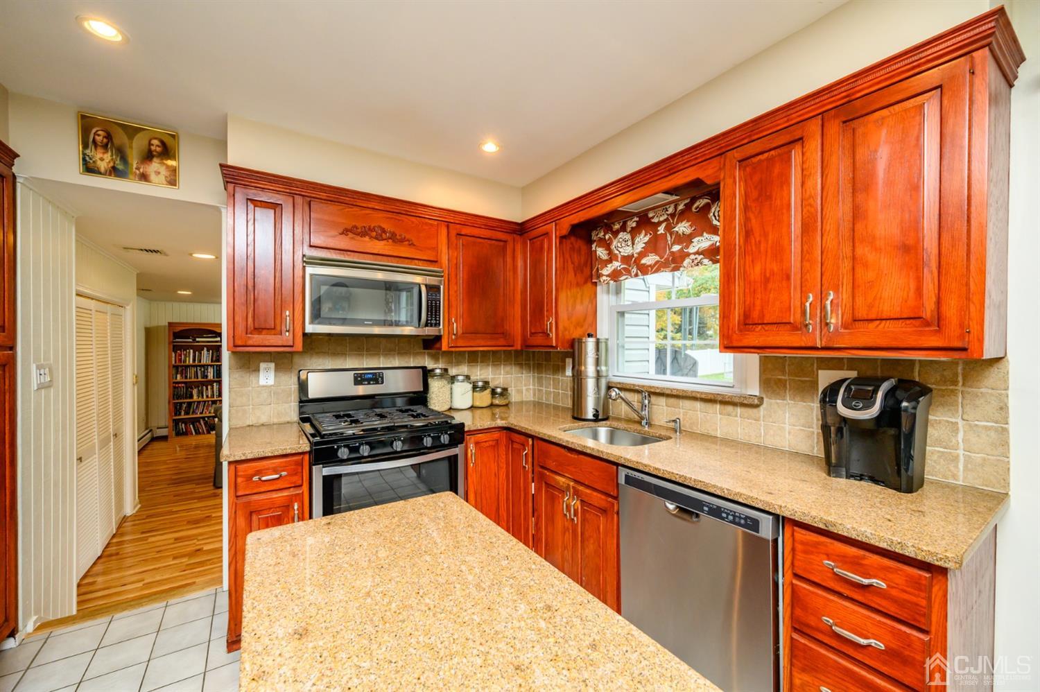 24 Clover Lane Randolph, NJ 07869 - Photo 15 of 59 a kitchen with stainless steel appliances a stove sink and cabinets