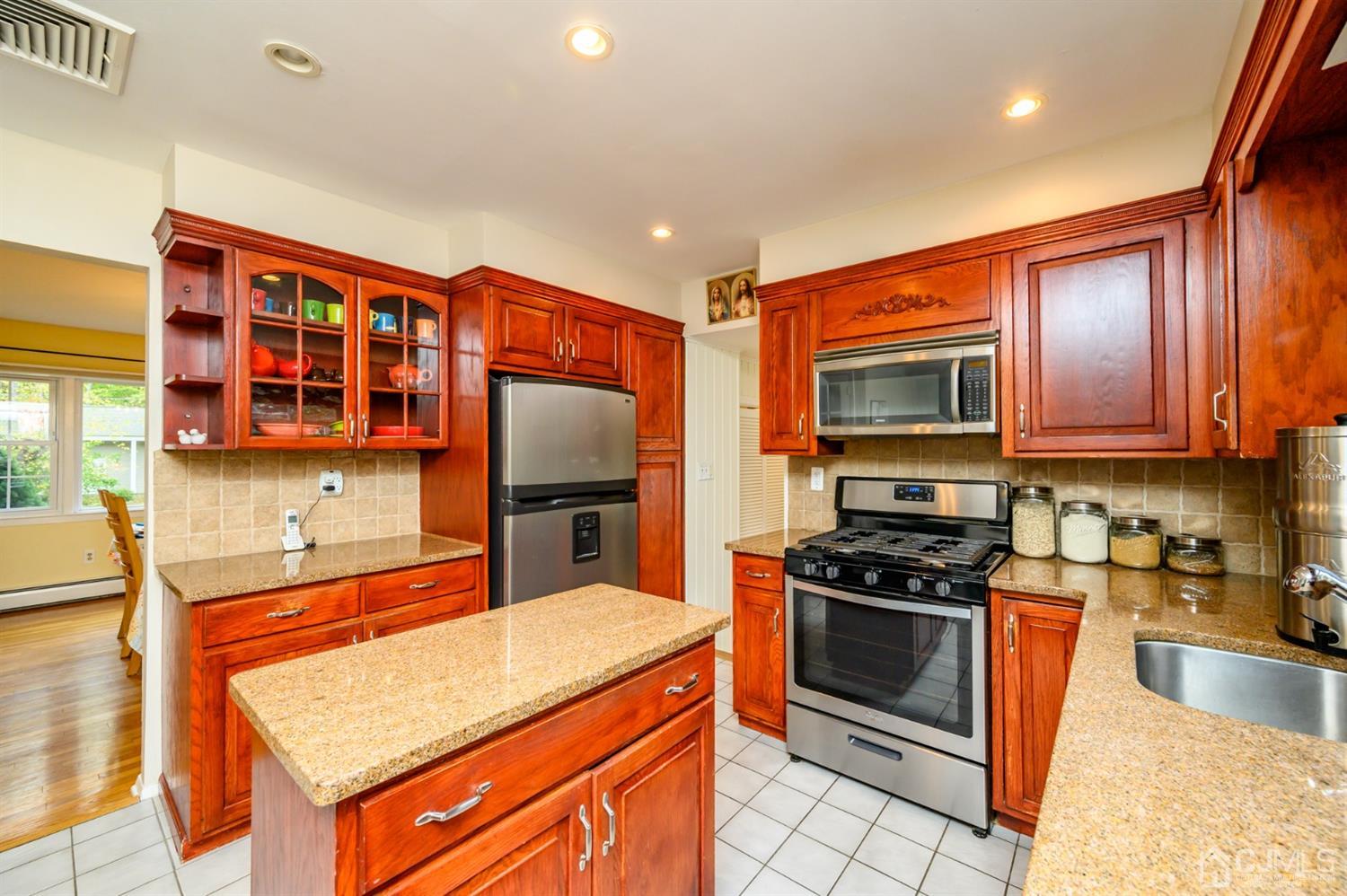 24 Clover Lane Randolph, NJ 07869 - Photo 16 of 59 a kitchen with stainless steel appliances granite countertop a stove a sink and a microwave