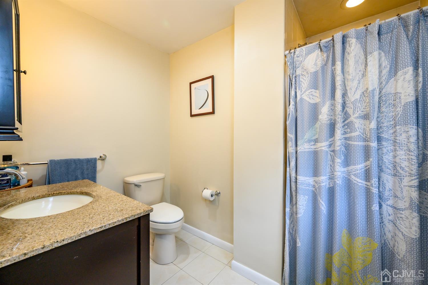 24 Clover Lane Randolph, NJ 07869 - Photo 27 of 59 a bathroom with a granite countertop sink and a mirror