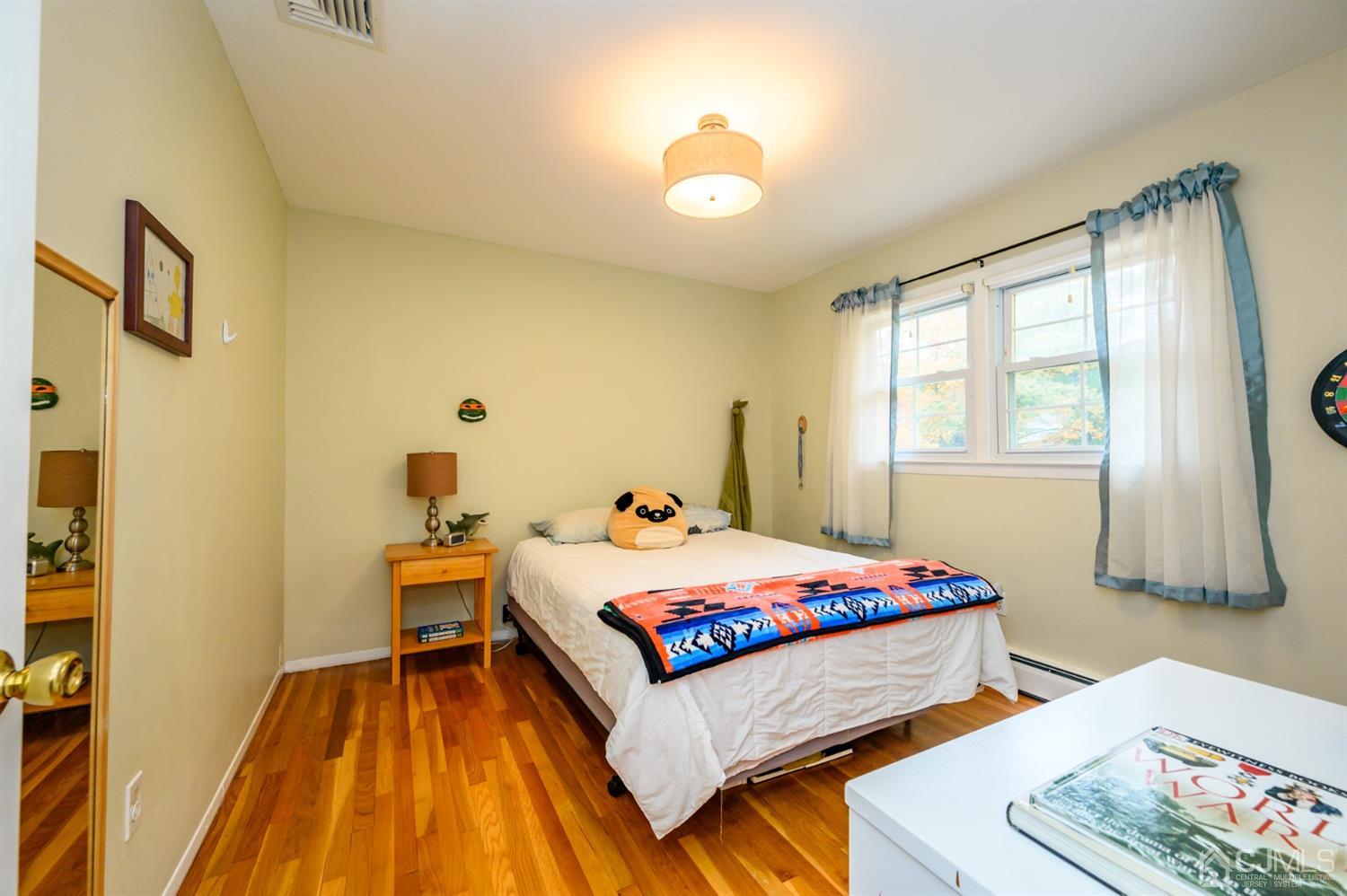 24 Clover Lane Randolph, NJ 07869 - Photo 29 of 59 a bedroom with a bed and wooden floor