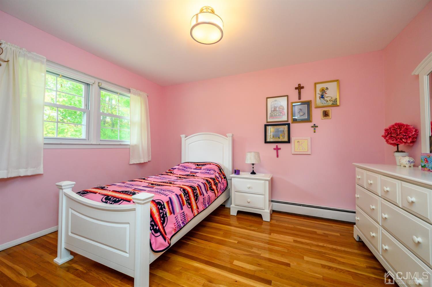 24 Clover Lane Randolph, NJ 07869 - Photo 32 of 59 a bedroom with a bed and wooden floor