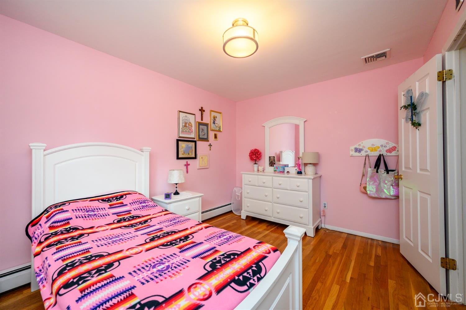 24 Clover Lane Randolph, NJ 07869 - Photo 33 of 59 a bedroom with a bed and a mirror