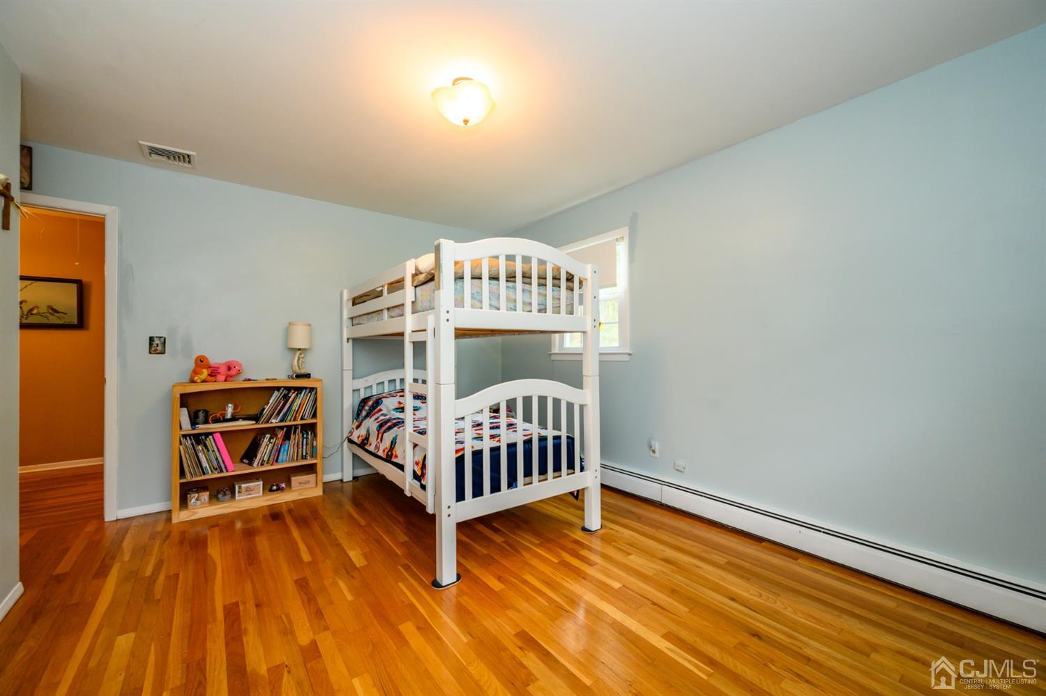24 Clover Lane Randolph, NJ 07869 - Photo 36 of 59 a bedroom with furniture and a wooden floor