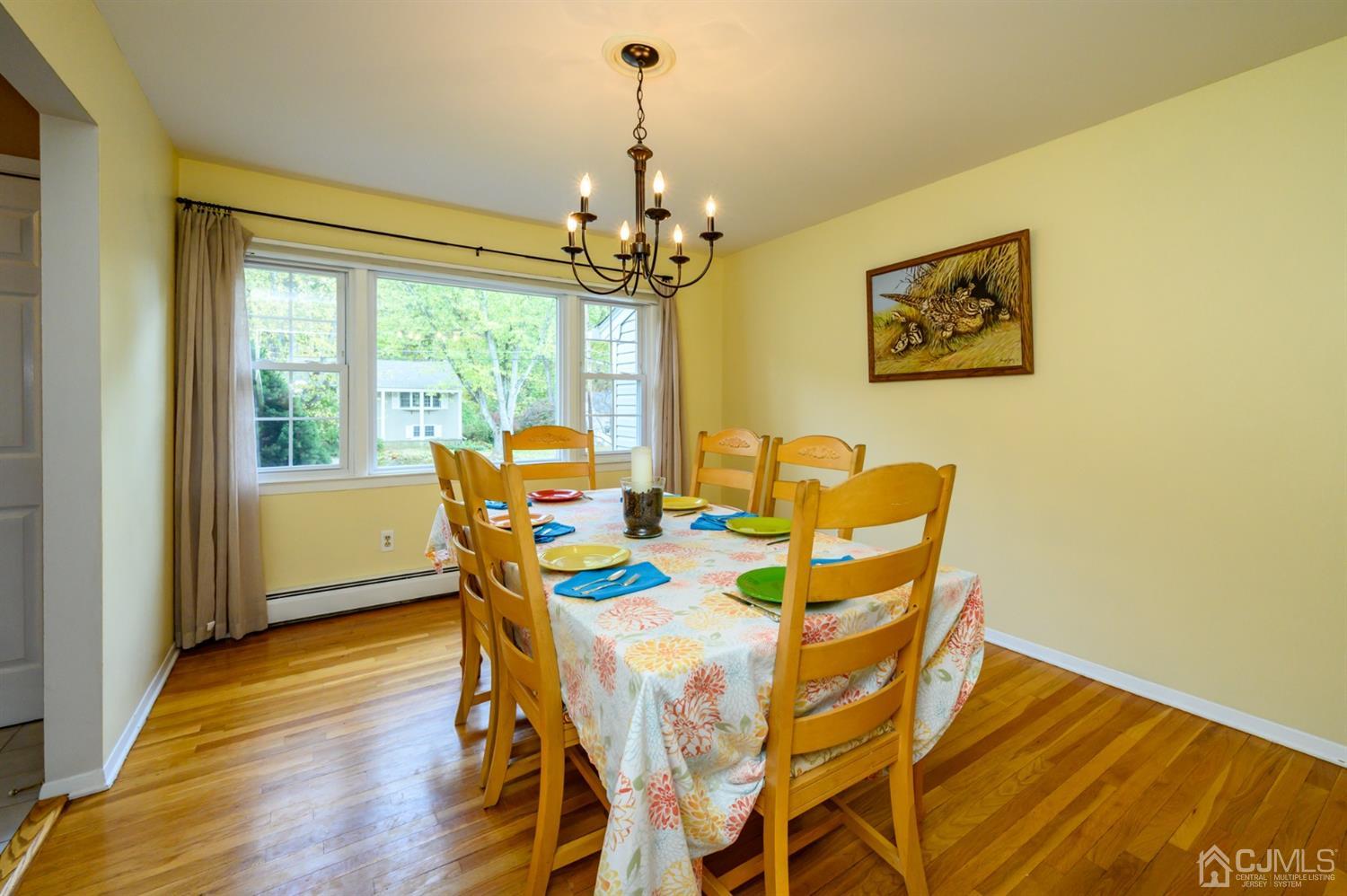 24 Clover Lane Randolph, NJ 07869 - Photo 5 of 59 a dining room with furniture a chandelier and wooden floor