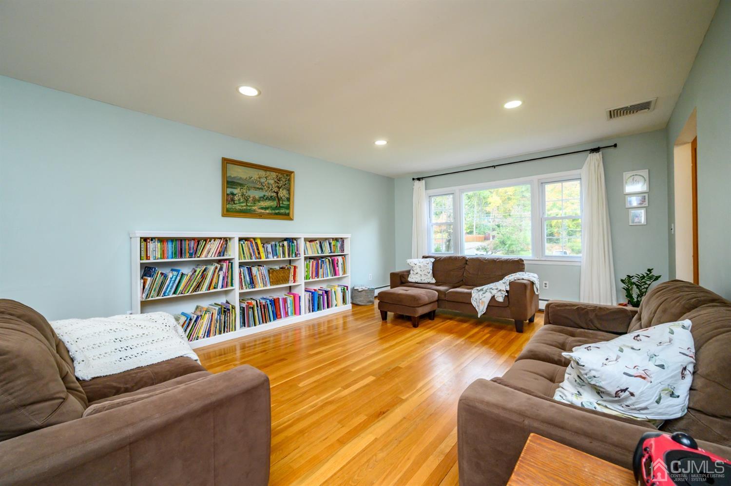 24 Clover Lane Randolph, NJ 07869 - Photo 10 of 59 a living room with furniture and a book shelf