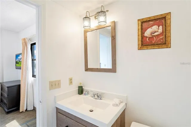 a bathroom with a sink toilet and vanity
