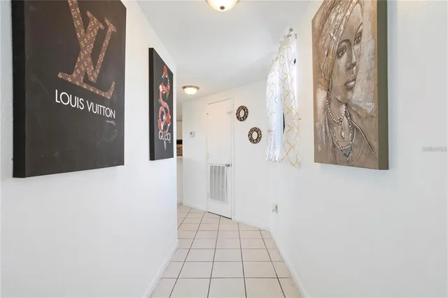 a living room with furniture and a kitchen area