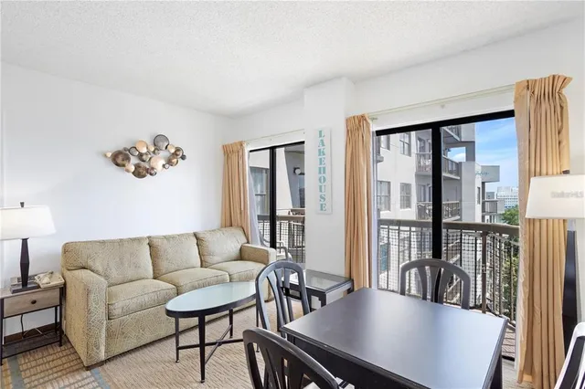a kitchen with stainless steel appliances kitchen island granite countertop a sink and a refrigerator