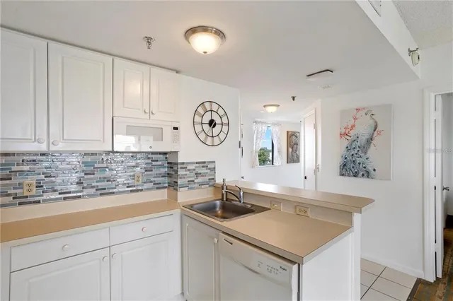 a white refrigerator freezer sitting inside of a kitchen