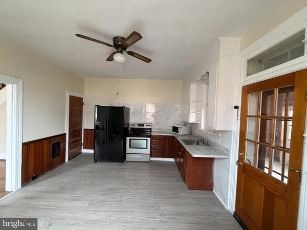 a kitchen with stainless steel appliances granite countertop a refrigerator stove top oven and sink