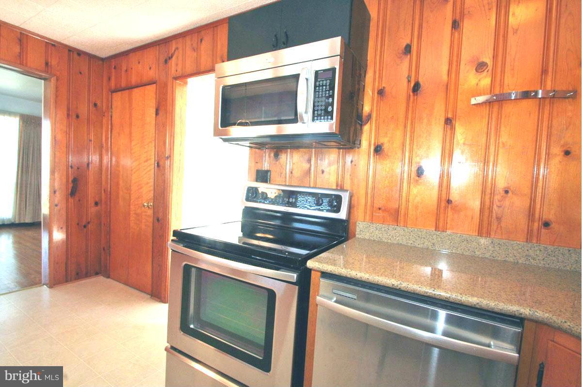 1604 Lynch Road Dundalk, MD 21222 - Photo 6 of 30 a kitchen with a stove and a microwave