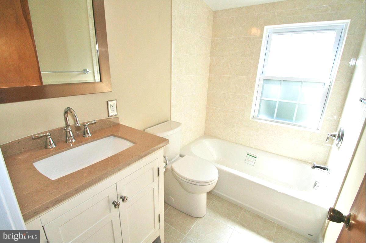 1604 Lynch Road Dundalk, MD 21222 - Photo 8 of 30 a bathroom with a sink and a mirror