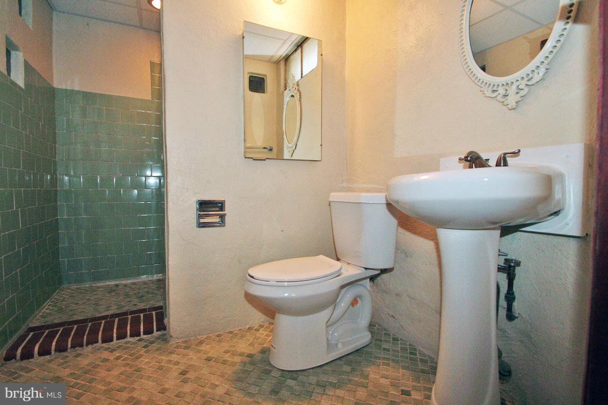 1604 Lynch Road Dundalk, MD 21222 - Photo 9 of 30 a bathroom with a sink toilet and a mirror