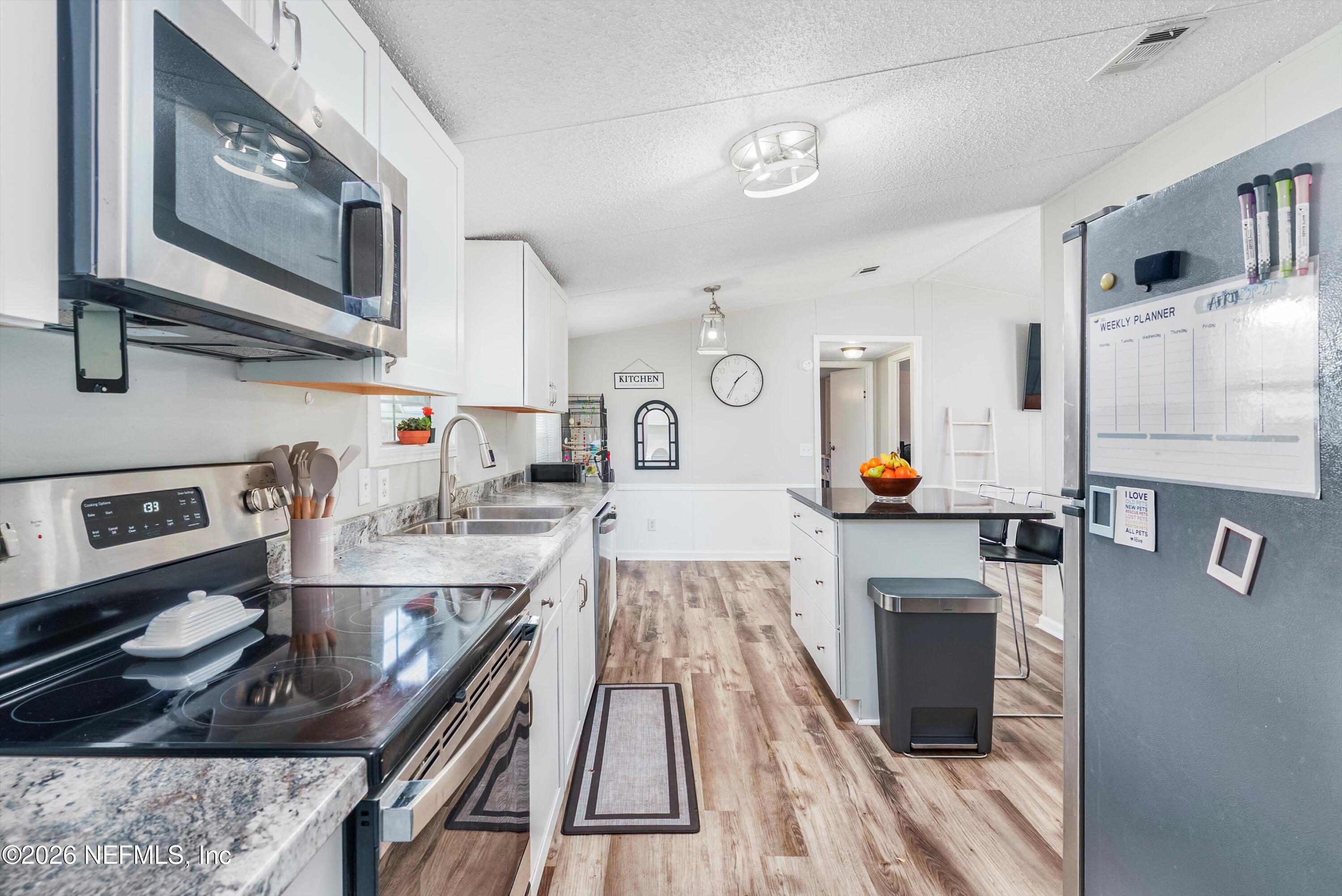 85246 Johnson Lane Yulee, FL 32097 - Photo 12 of 46 a kitchen with stainless steel appliances granite countertop a stove and a sink