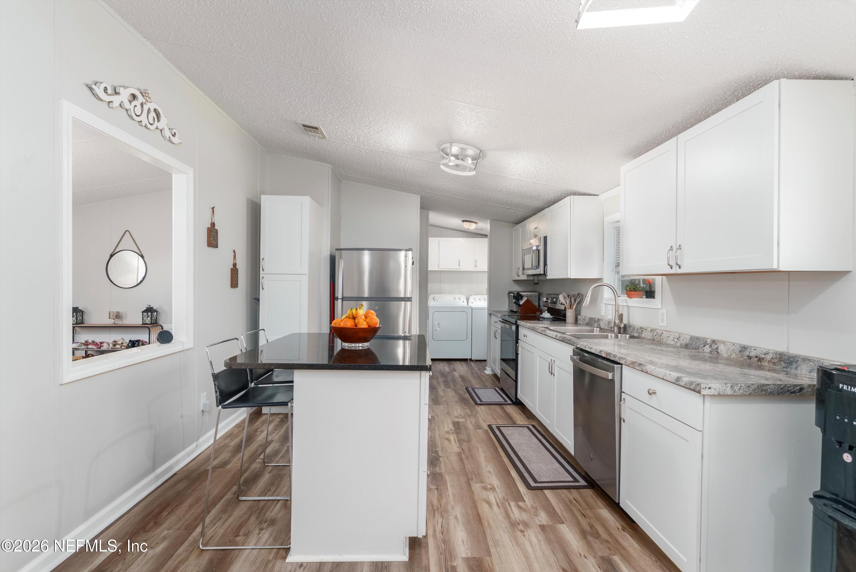85246 Johnson Lane Yulee, FL 32097 - Photo 14 of 46 a kitchen with stainless steel appliances a stove a sink and a refrigerator