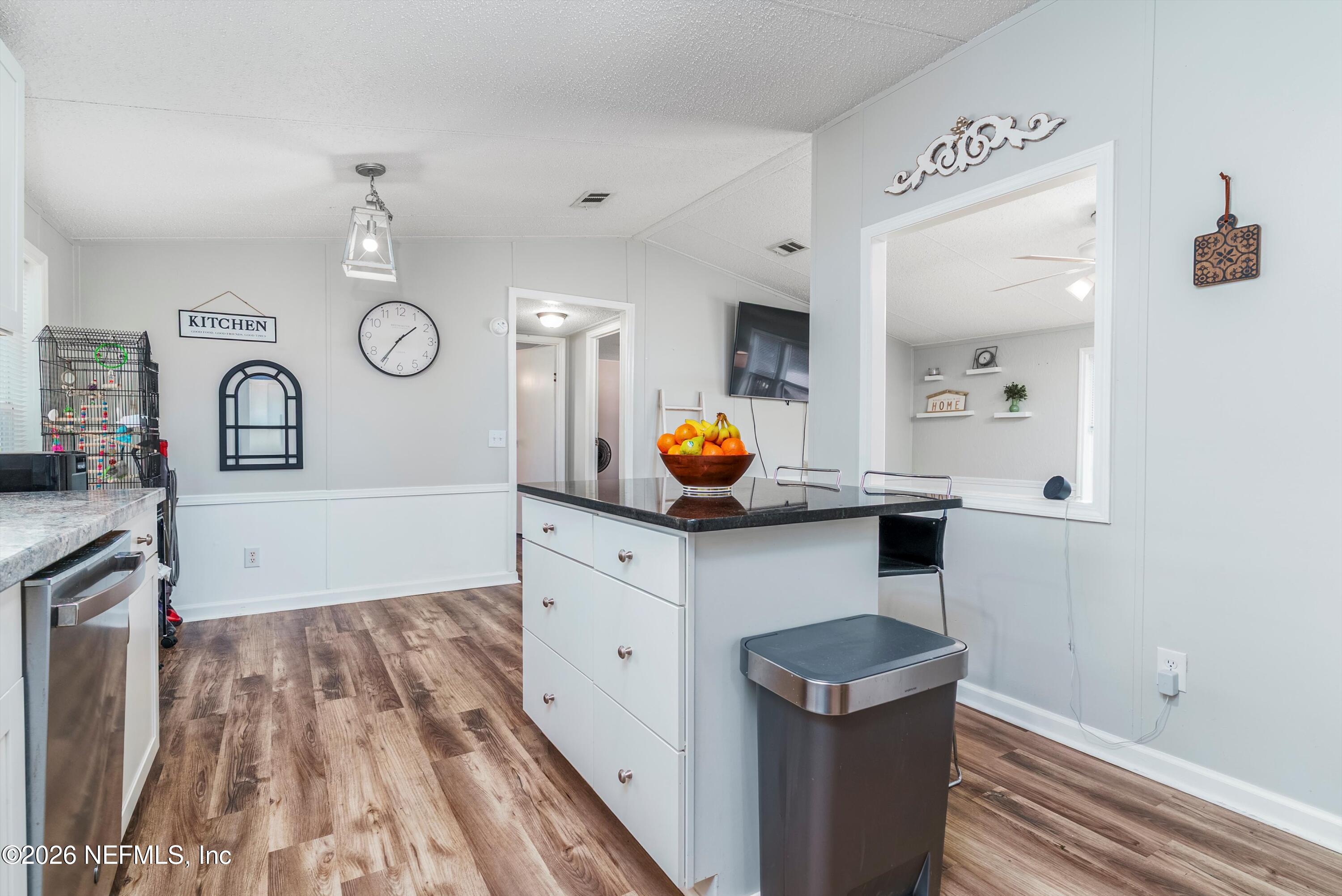 85246 Johnson Lane Yulee, FL 32097 - Photo 15 of 46 a kitchen with a refrigerator a stove and wooden floor