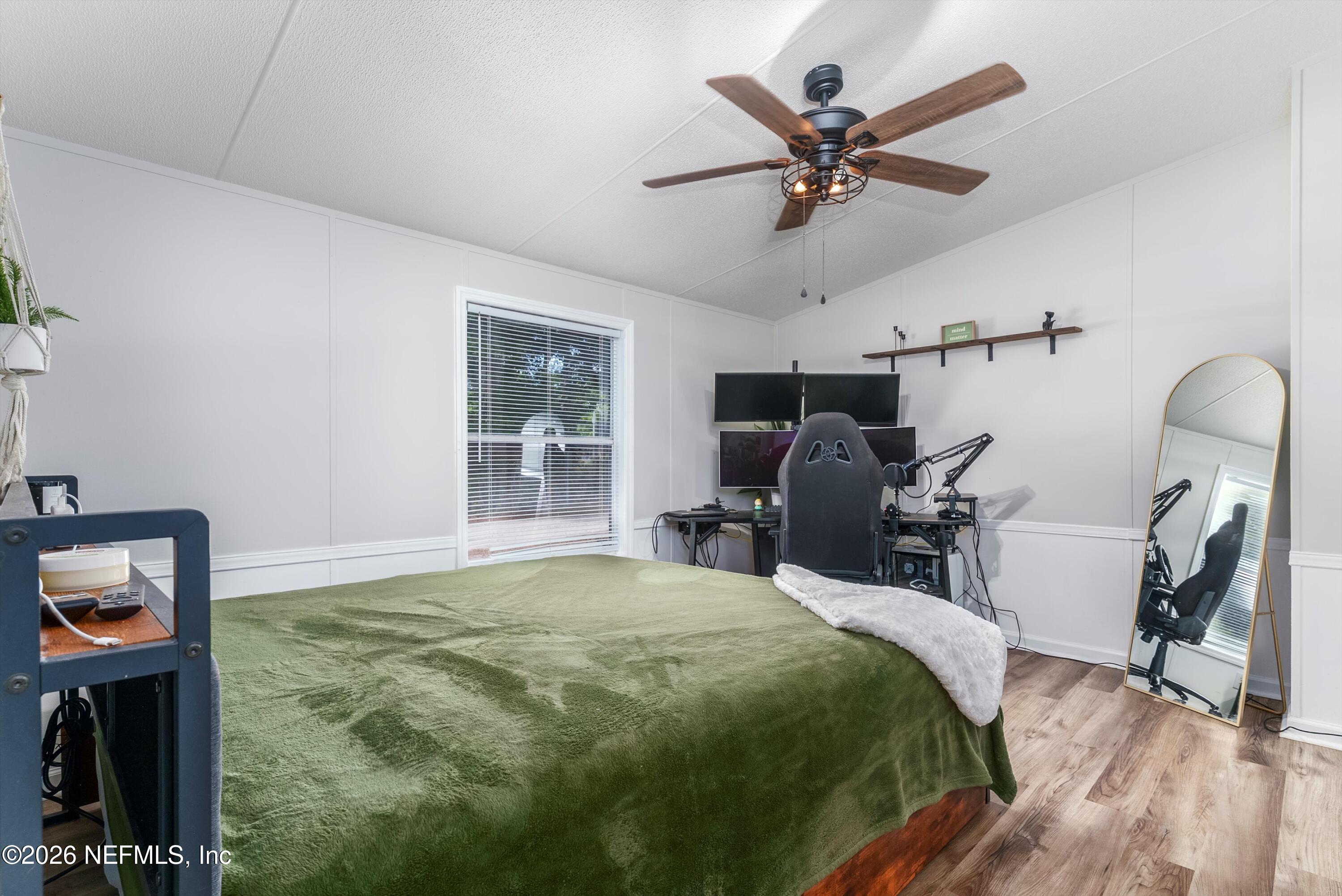 85246 Johnson Lane Yulee, FL 32097 - Photo 16 of 46 a bedroom with bed a mirror and a window