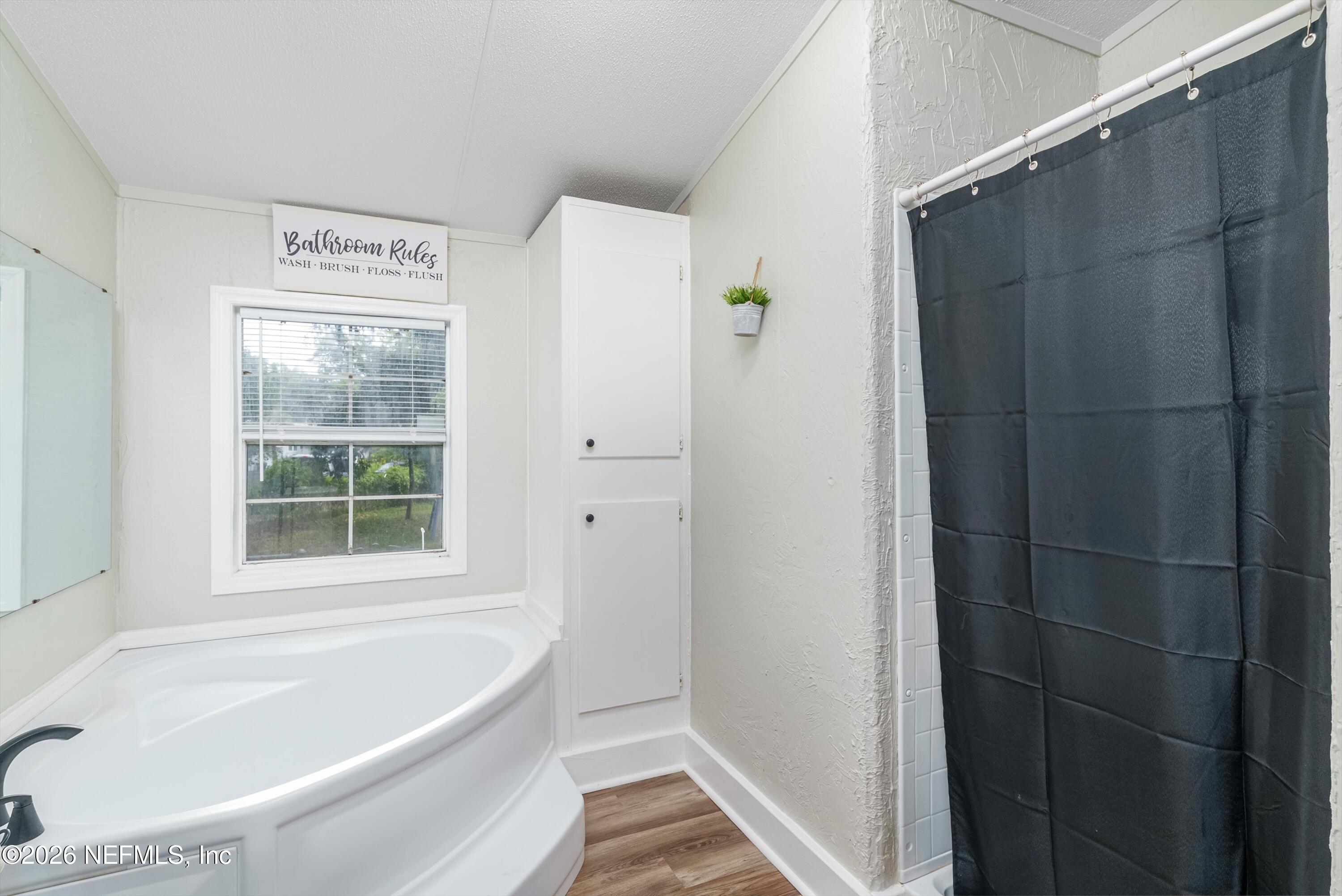 85246 Johnson Lane Yulee, FL 32097 - Photo 19 of 46 a bathroom with a bathtub and a shower