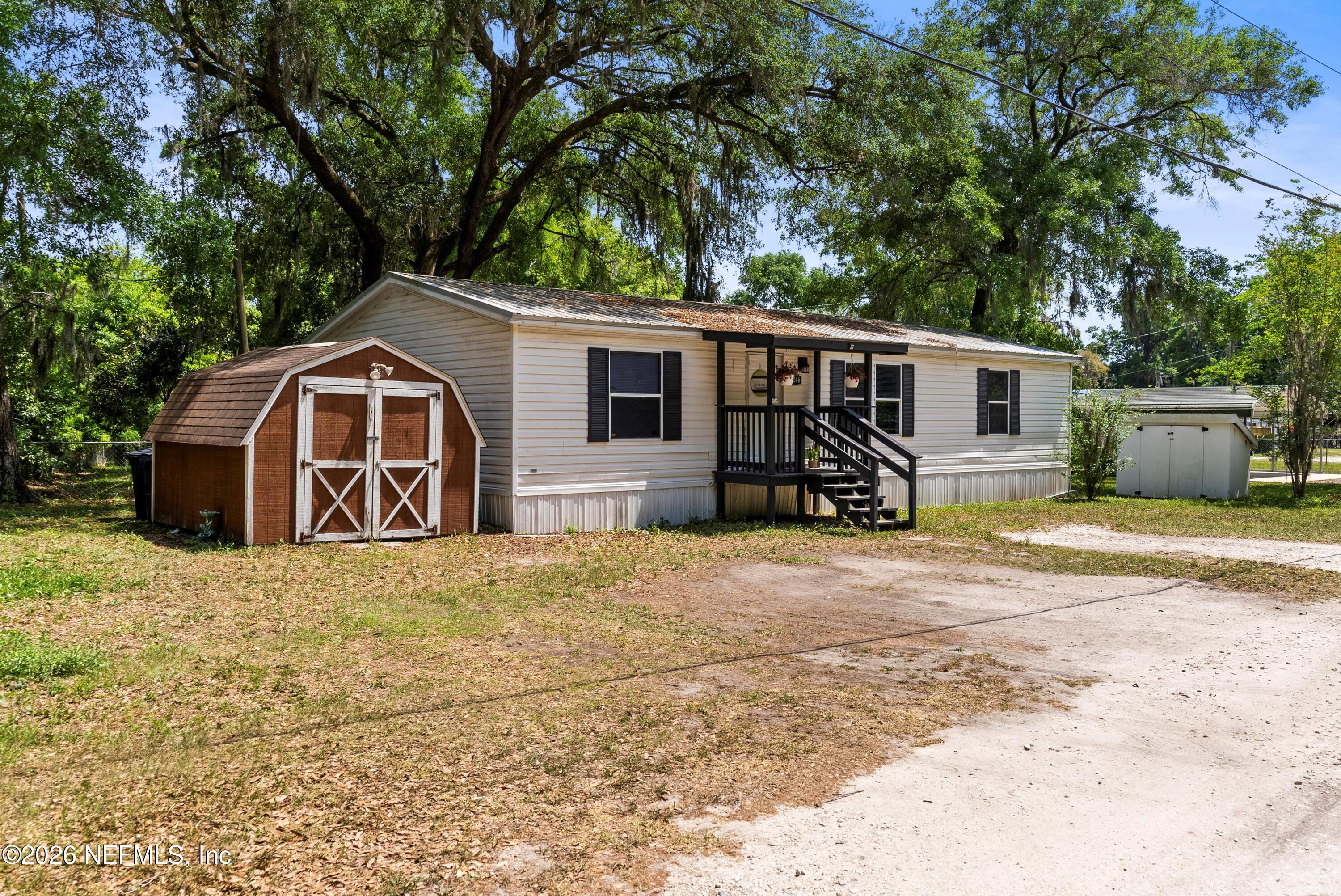 85246 Johnson Lane Yulee, FL 32097 - Photo 2 of 46 a front view of a house with a yard and garage