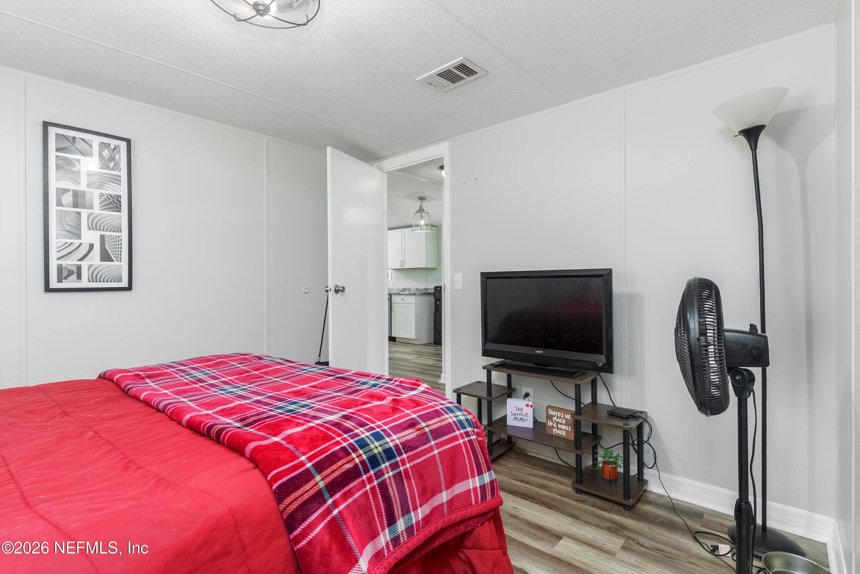 85246 Johnson Lane Yulee, FL 32097 - Photo 22 of 46 a bedroom with a bed and a flat screen tv