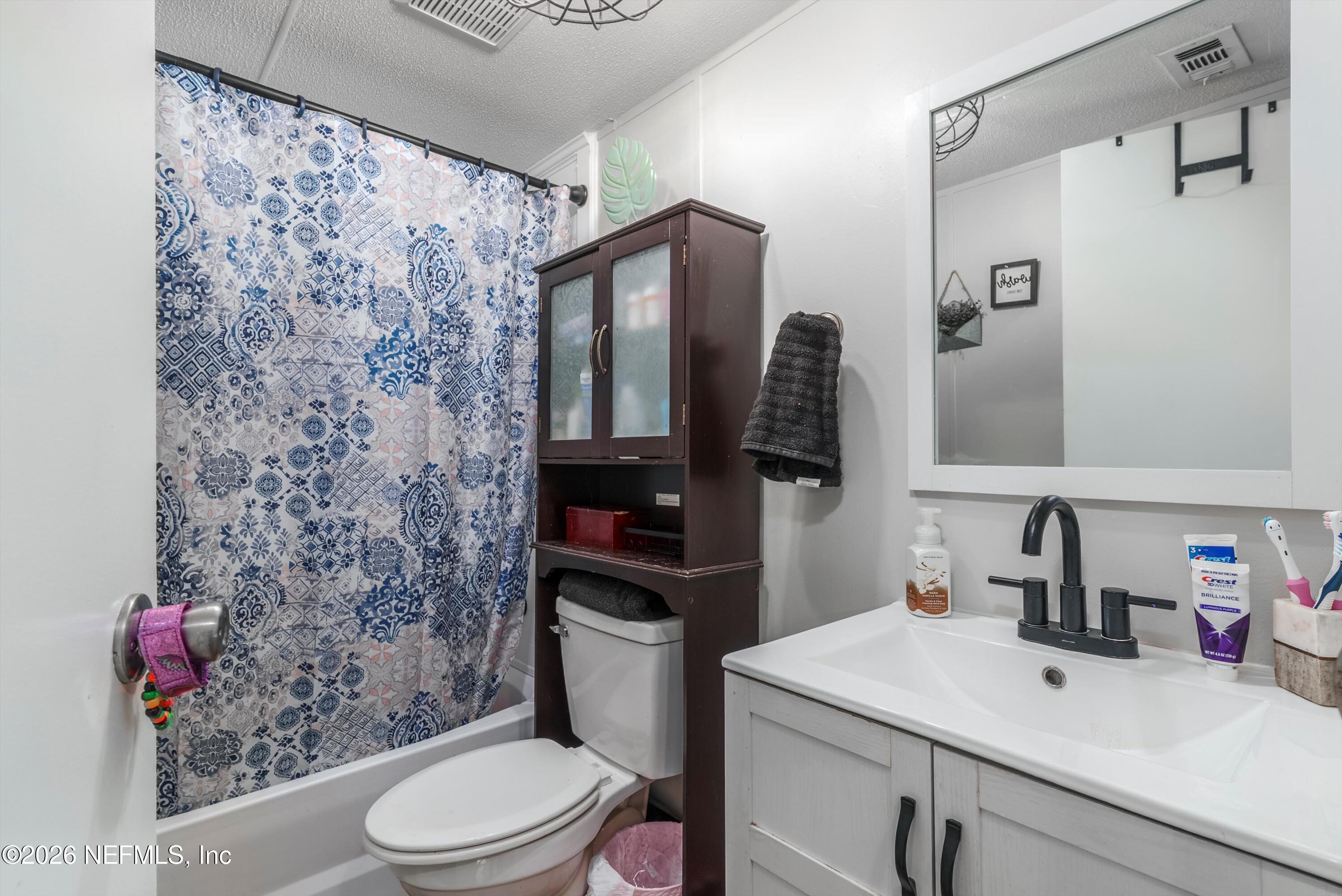 85246 Johnson Lane Yulee, FL 32097 - Photo 23 of 46 a bathroom with a sink toilet and shower
