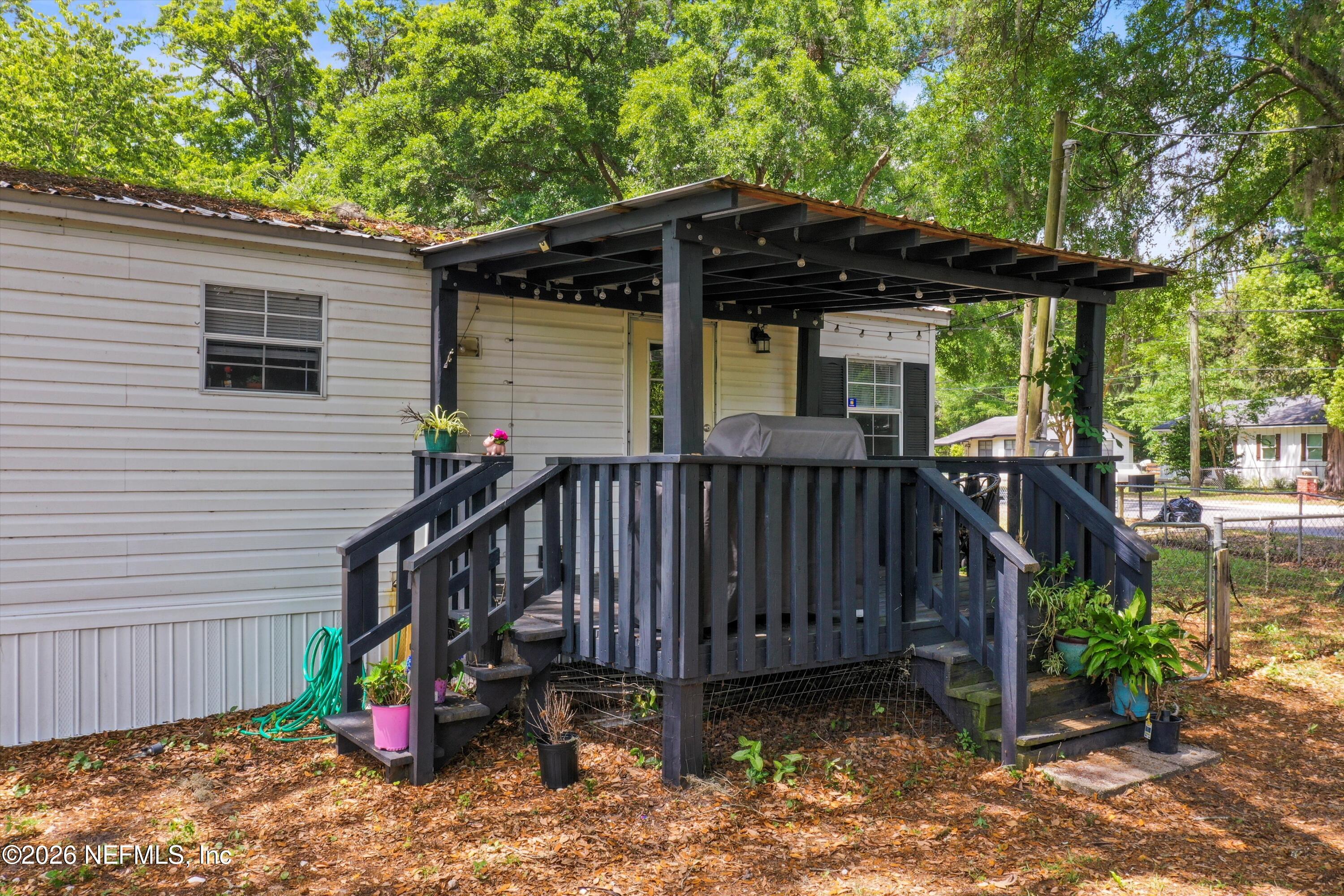 85246 Johnson Lane Yulee, FL 32097 - Photo 28 of 46 a view of a chair and table in the backyard