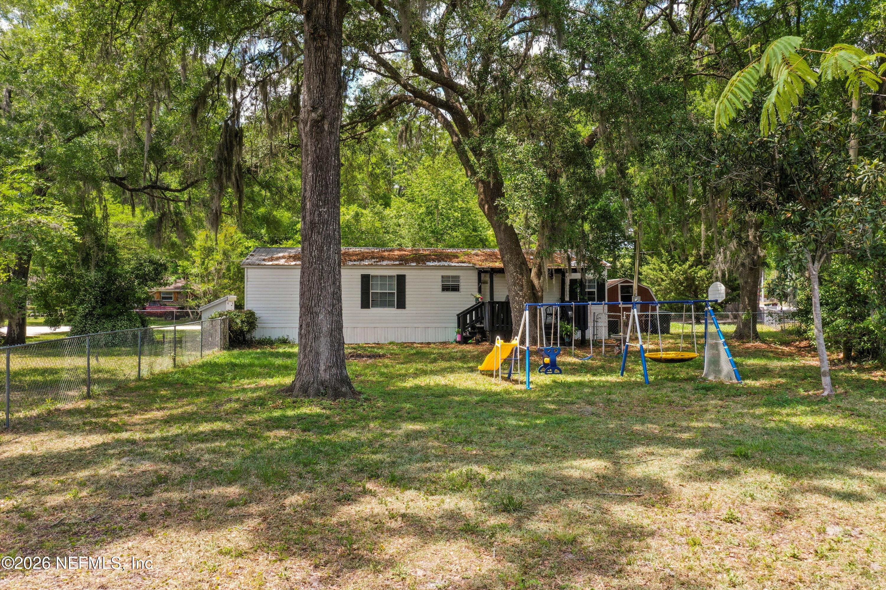 85246 Johnson Lane Yulee, FL 32097 - Photo 33 of 46 a view of a house with a backyard