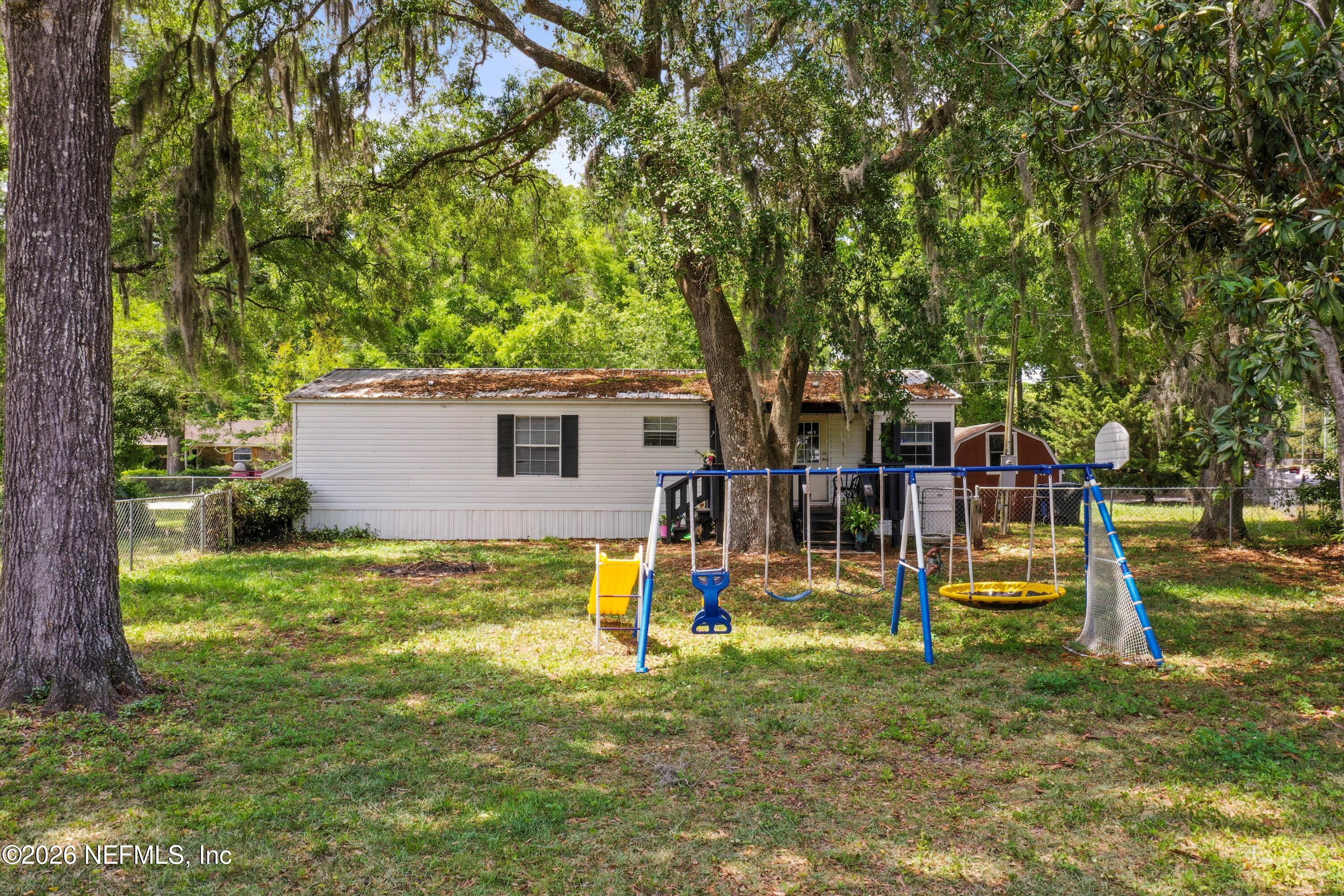 85246 Johnson Lane Yulee, FL 32097 - Photo 38 of 46 a view of a house with a yard and tree