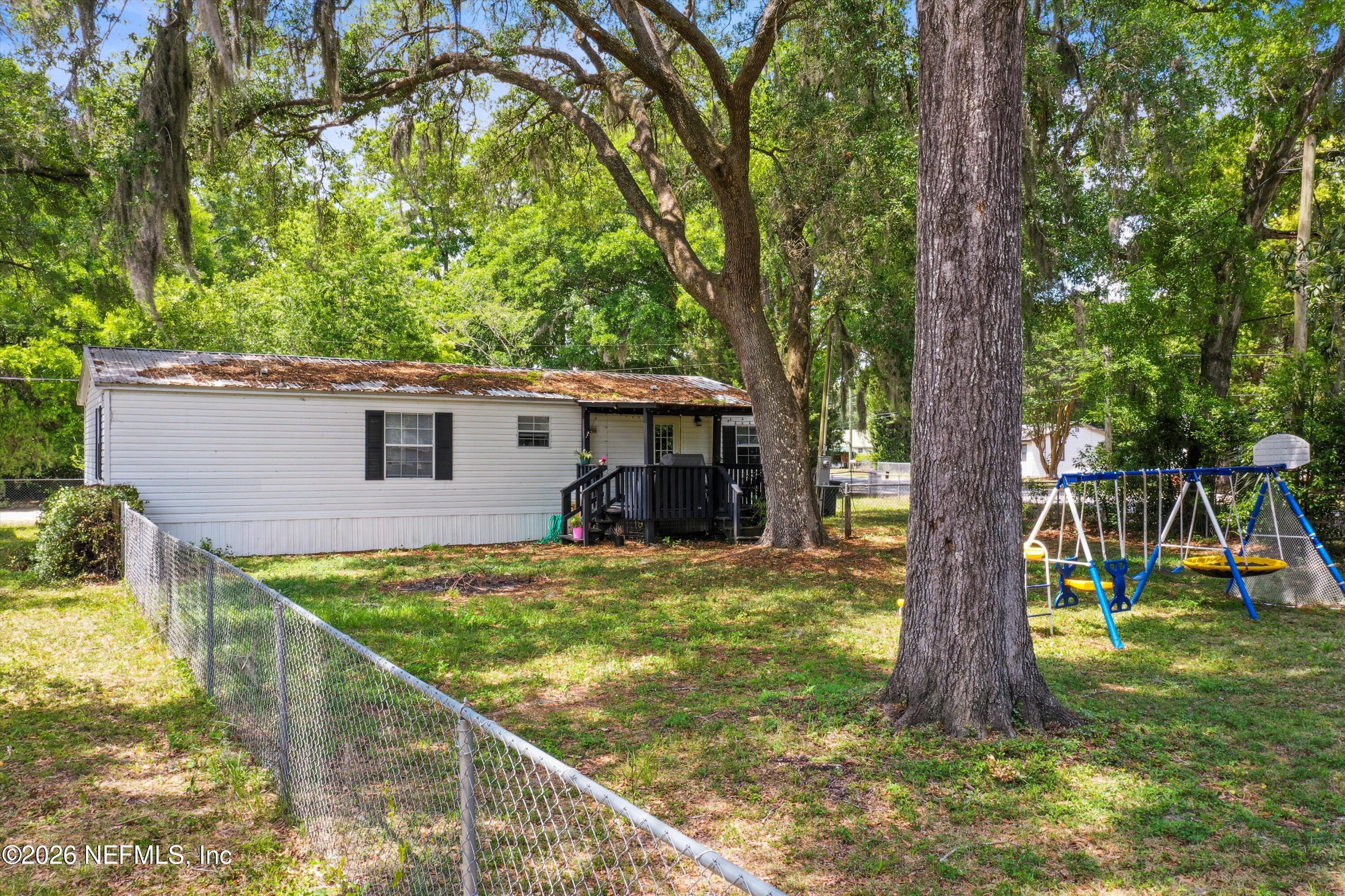 85246 Johnson Lane Yulee, FL 32097 - Photo 39 of 46 a view of a house with backyard and a tree