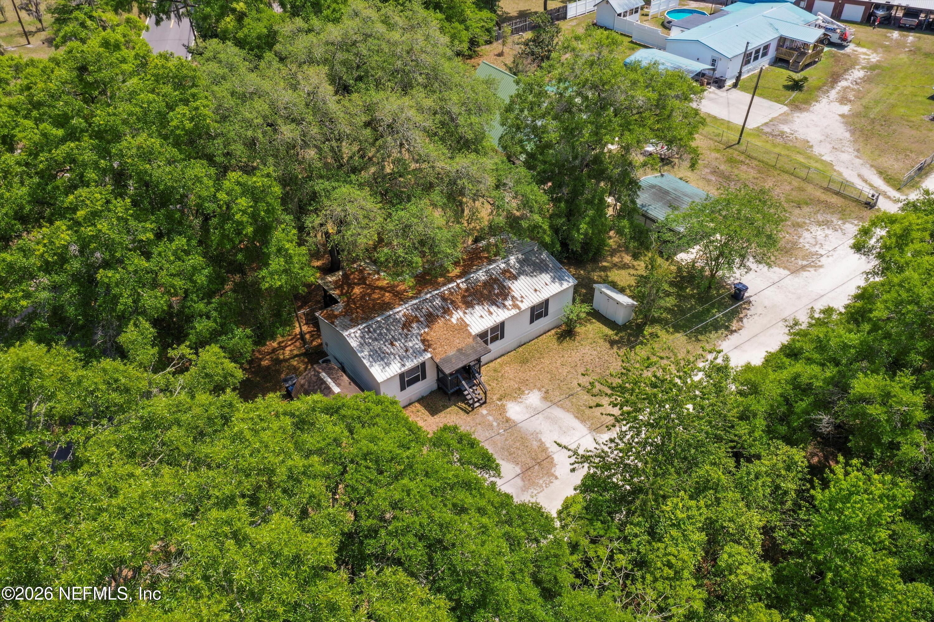 85246 Johnson Lane Yulee, FL 32097 - Photo 40 of 46 an aerial view of residential house with outdoor space and trees all around