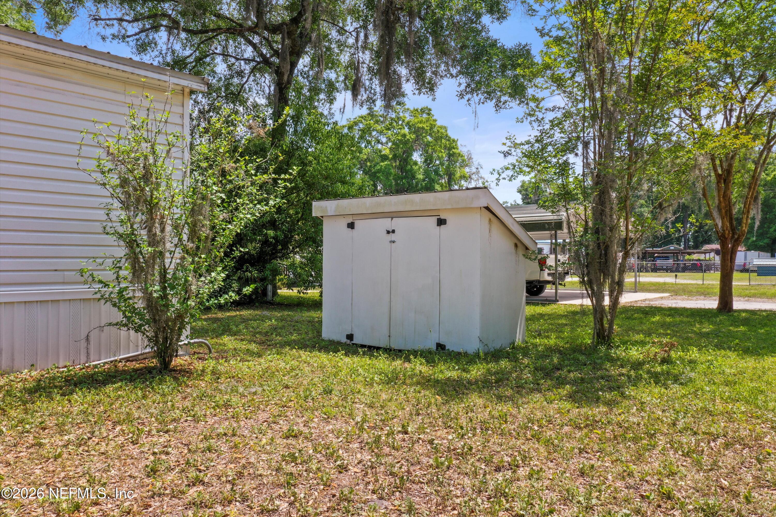 85246 Johnson Lane Yulee, FL 32097 - Photo 43 of 46 a wooden house with a yard and large trees