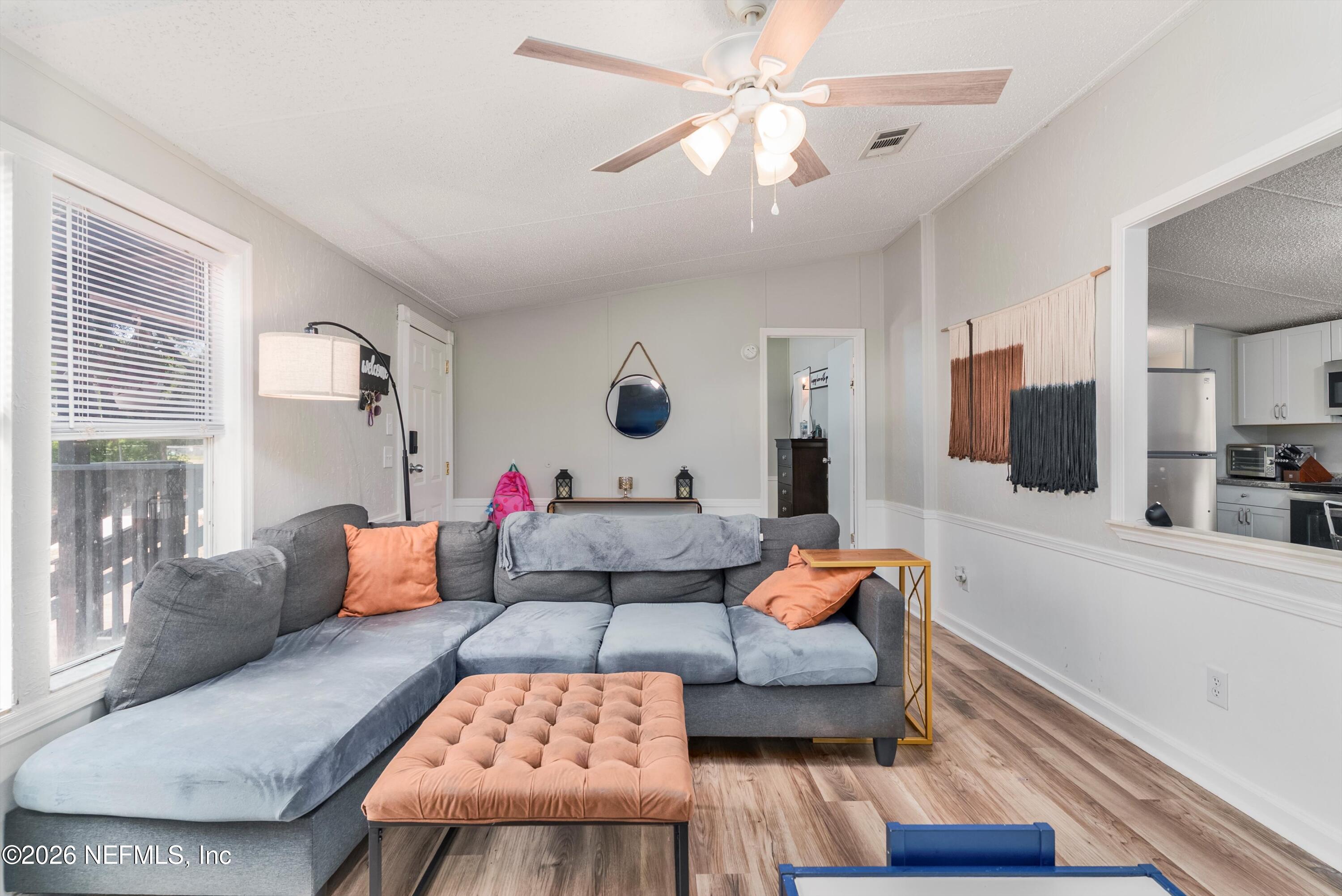 85246 Johnson Lane Yulee, FL 32097 - Photo 7 of 46 a living room with furniture and a flat screen tv