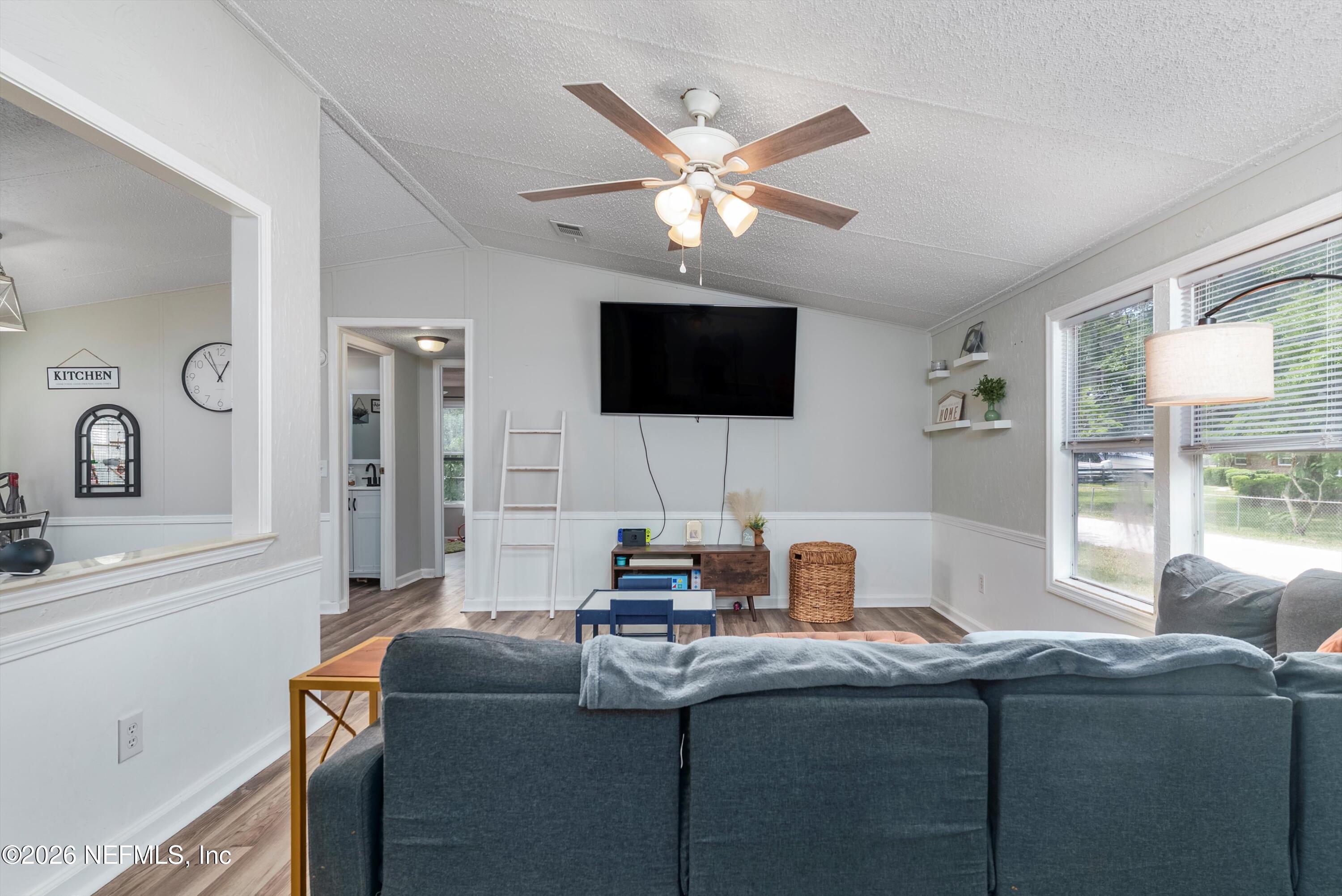85246 Johnson Lane Yulee, FL 32097 - Photo 8 of 46 a work room with furniture and a flat screen tv