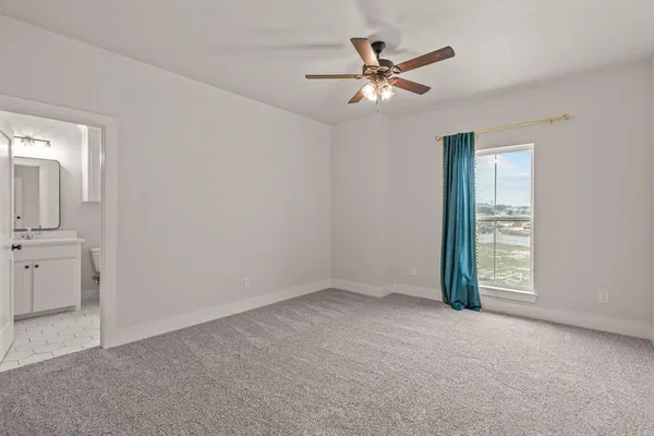 an empty room with closet and windows