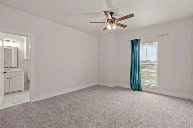 an empty room with closet and windows